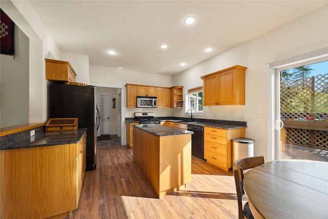 13471 Sundance Trl, Bigfork, MT 59911 - kitchen featuring appliances with stainless steel finishes, a kitchen island, wood finished floors, open shelves, and recessed lighting