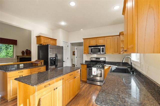 13471 Sundance Trl, Bigfork, MT 59911 - kitchen with stainless steel appliances, a kitchen island, dark stone countertops, recessed lighting, and dark wood finished floors