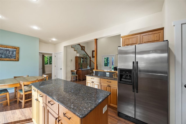 13471 Sundance Trl, Bigfork, MT 59911 - kitchen with stainless steel fridge, dark wood finished floors, a center island, dark stone counters, and recessed lighting