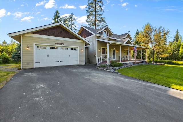 13471 Sundance Trl, Bigfork, MT 59911 - view of front of house with covered porch, an attached garage, driveway, and a front yard