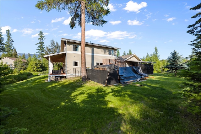 13471 Sundance Trl, Bigfork, MT 59911 - rear view of property with a lawn