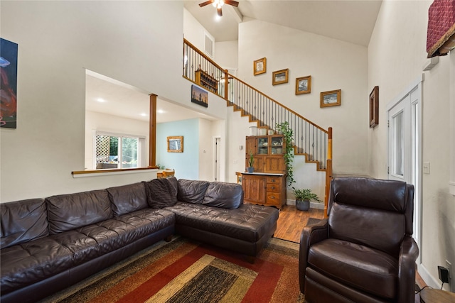 13471 Sundance Trl, Bigfork, MT 59911 - living area featuring a high ceiling, a ceiling fan, stairs, and wood finished floors