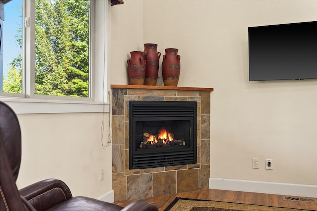 13471 Sundance Trl, Bigfork, MT 59911 - living area with a tiled fireplace and wood finished floors