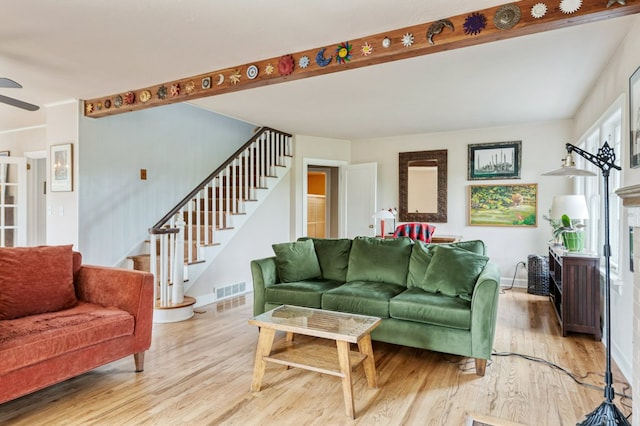 2606 View Dr, Missoula, MT 59804 - living area with stairs, light wood-style flooring, ceiling fan, baseboards, and beam ceiling