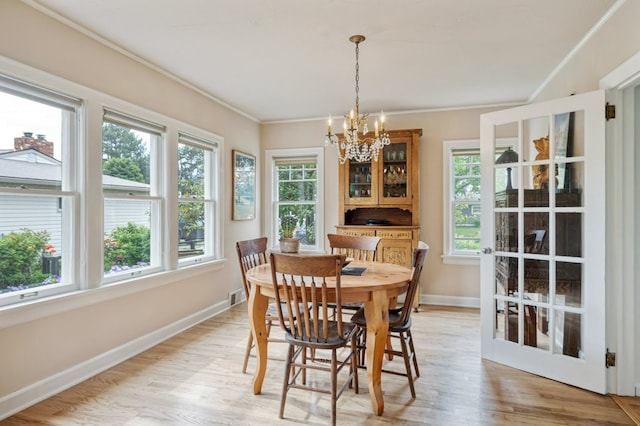 2606 View Dr, Missoula, MT 59804 - dining room with a chandelier, baseboards, ornamental molding, and light wood-type flooring