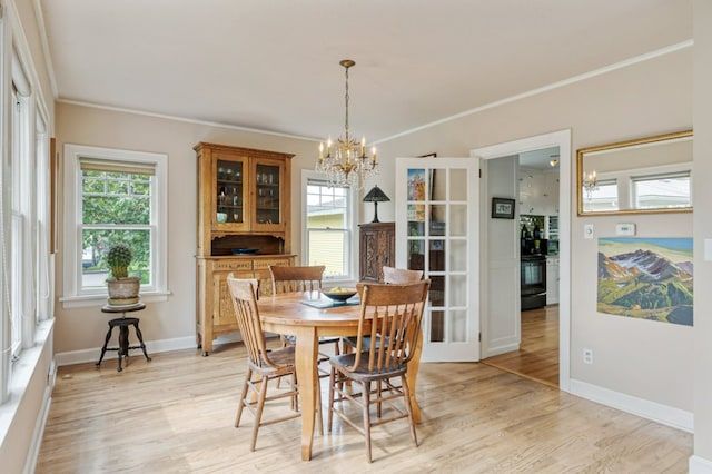 2606 View Dr, Missoula, MT 59804 - dining room with light wood-style flooring, crown molding, a chandelier, and baseboards