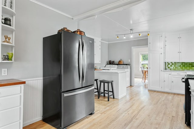 2606 View Dr, Missoula, MT 59804 - kitchen featuring freestanding refrigerator, independent washer and dryer, white cabinets, open shelves, and crown molding