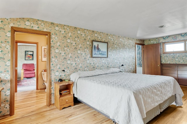 2606 View Dr, Missoula, MT 59804 - bedroom with wallpapered walls, light wood finished floors, and vaulted ceiling