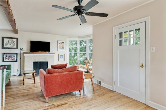 2606 View Dr, Missoula, MT 59804 - living room with plenty of natural light, light wood finished floors, a brick fireplace, and a ceiling fan