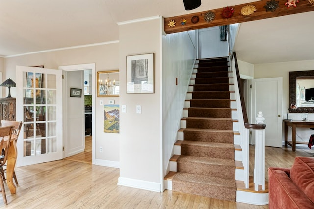 2606 View Dr, Missoula, MT 59804 - stairs with wood finished floors, baseboards, crown molding, and a chandelier