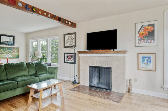 2606 View Dr, Missoula, MT 59804 - living area with baseboards, wood finished floors, a fireplace, and beam ceiling