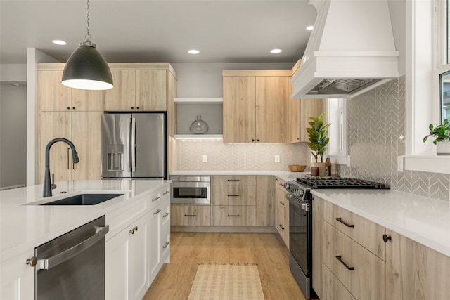 7018 Max Dr, Missoula, MT 59803 - kitchen featuring light brown cabinets, stainless steel appliances, premium range hood, a sink, and recessed lighting
