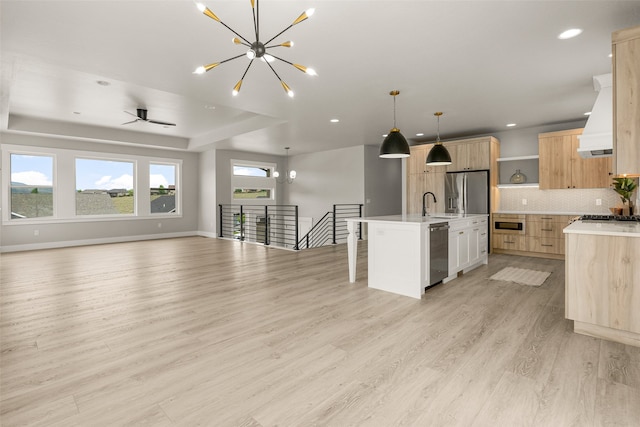 7018 Max Dr, Missoula, MT 59803 - kitchen with open shelves, appliances with stainless steel finishes, light brown cabinets, custom range hood, and open floor plan