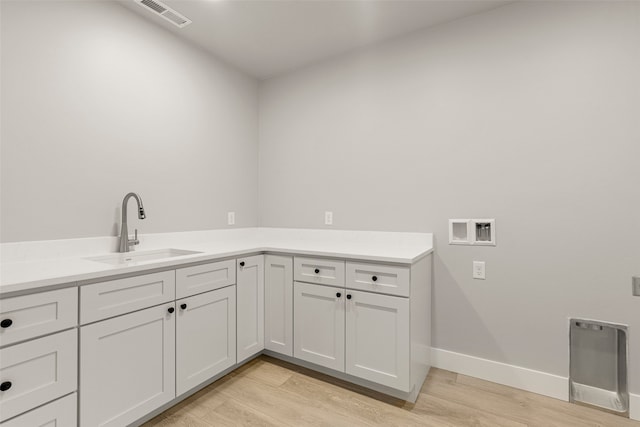 7018 Max Dr, Missoula, MT 59803 - washroom with light wood finished floors, cabinet space, hookup for a washing machine, and baseboards