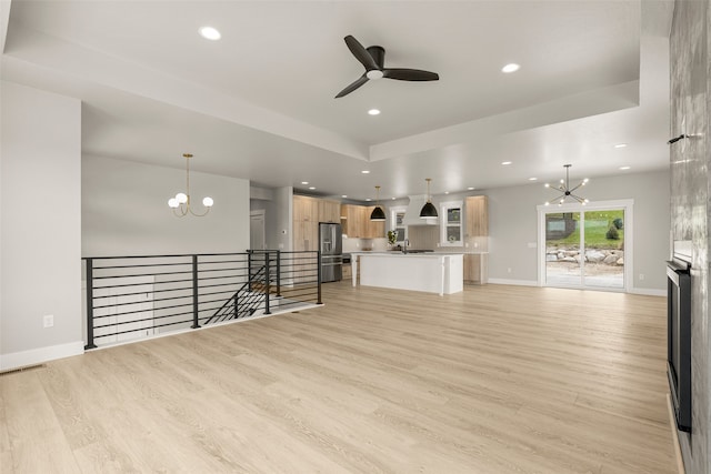 7018 Max Dr, Missoula, MT 59803 - unfurnished living room featuring a chandelier, ceiling fan, recessed lighting, light wood-type flooring, and baseboards