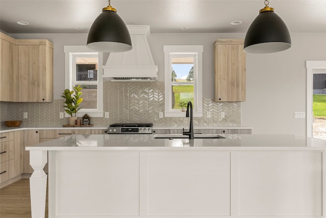 7018 Max Dr, Missoula, MT 59803 - kitchen featuring light brown cabinetry, custom exhaust hood, a sink, and gas stove