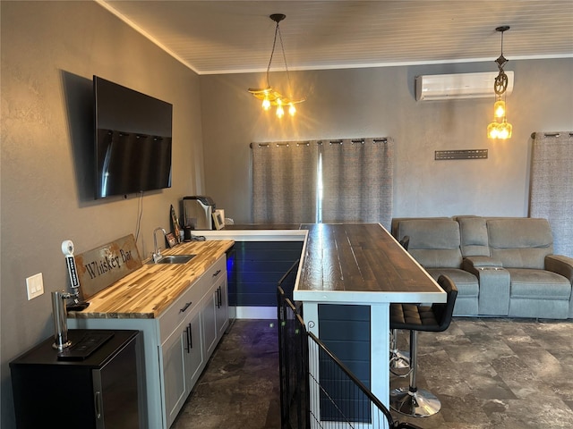 411 10th Ave NE, Choteau, MT 59422 - kitchen featuring wood counters, a wall mounted air conditioner, a sink, crown molding, and pendant lighting