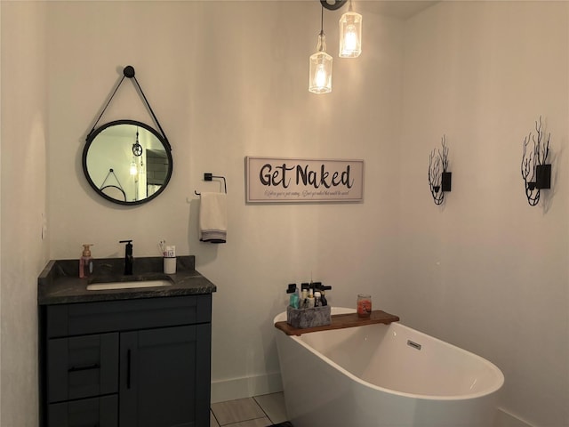411 10th Ave NE, Choteau, MT 59422 - bathroom with a soaking tub, vanity, tile patterned floors, and baseboards
