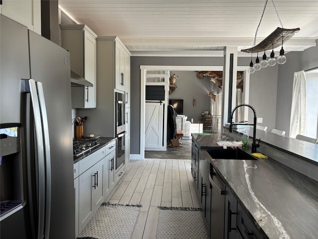 411 10th Ave NE, Choteau, MT 59422 - kitchen featuring stainless steel appliances, a sink, wood ceiling, light wood-style flooring, and dark stone countertops
