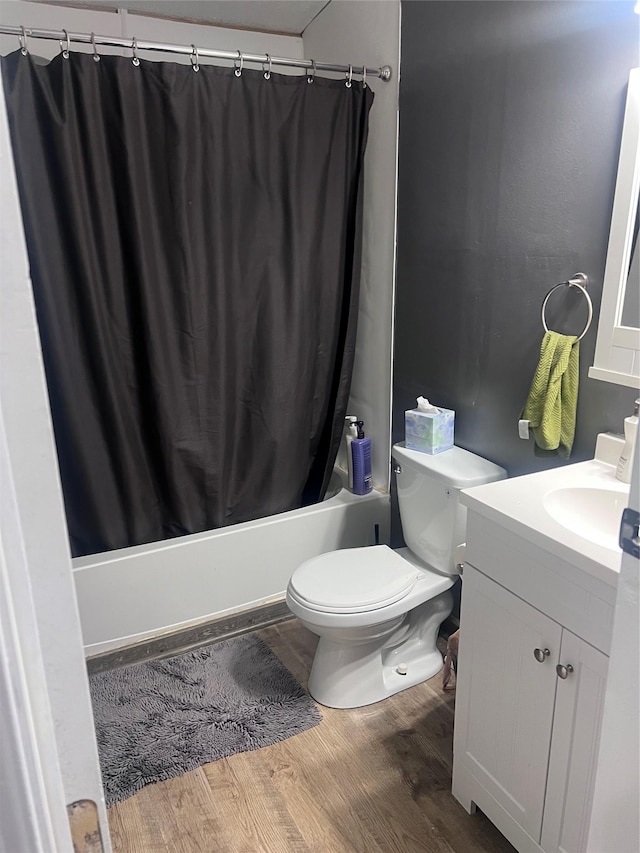 3000 Villard Ave Unit 12, Helena, MT 59601 - full bathroom with shower / bathtub combination with curtain, vanity, toilet, and wood finished floors