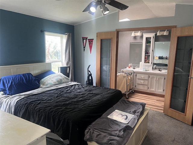 3000 Villard Ave Unit 12, Helena, MT 59601 - bedroom featuring a sink, a ceiling fan, light carpet, and ensuite bath