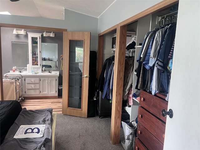 3000 Villard Ave Unit 12, Helena, MT 59601 - bedroom featuring crown molding, light colored carpet, vaulted ceiling, and a sink