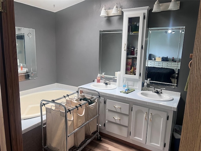 3000 Villard Ave Unit 12, Helena, MT 59601 - full bathroom featuring double vanity, a garden tub, and wood finished floors