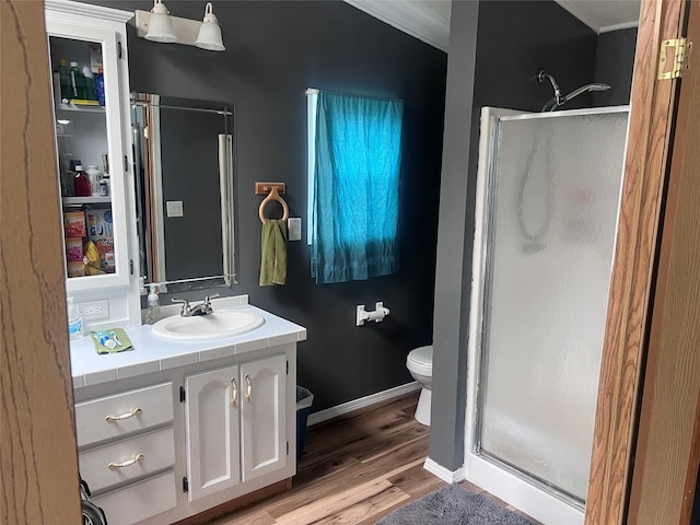 3000 Villard Ave Unit 12, Helena, MT 59601 - bathroom with a shower stall, toilet, vanity, wood finished floors, and ornamental molding