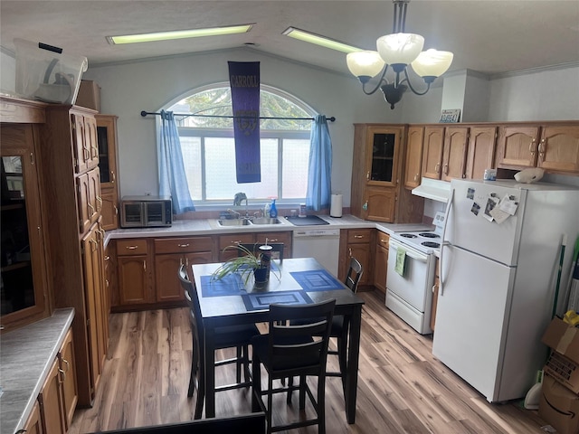 3000 Villard Ave Unit 12, Helena, MT 59601 - kitchen featuring white appliances, under cabinet range hood, a sink, a chandelier, and light wood-style flooring