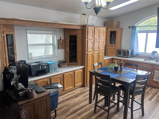 3000 Villard Ave Unit 12, Helena, MT 59601 - dining room with light wood finished floors, a chandelier, and crown molding