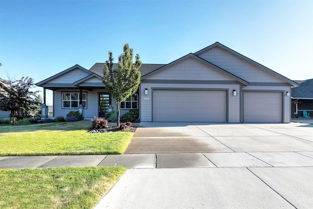 4995 Jeff Dr, Missoula, MT 59803 - view of front of property featuring an attached garage, concrete driveway, and a front lawn