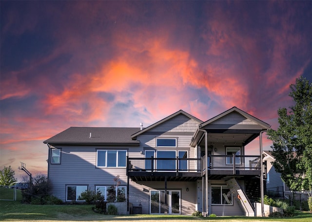 4995 Jeff Dr, Missoula, MT 59803 - back of house at dusk with a deck and a lawn