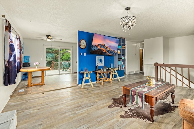 5900 Longview Dr, Missoula, MT 59803 - living area with a textured ceiling, a ceiling fan, wood finished floors, a chandelier, and baseboards