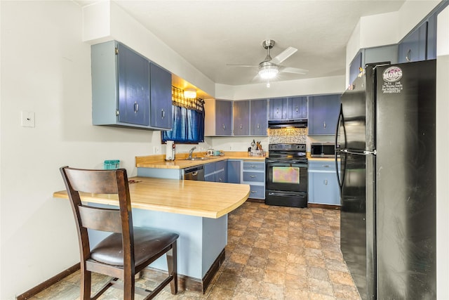 5900 Longview Dr, Missoula, MT 59803 - kitchen featuring black appliances, under cabinet range hood, a sink, a peninsula, and stone finish flooring