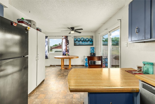 5900 Longview Dr, Missoula, MT 59803 - kitchen featuring freestanding refrigerator, blue cabinets, a ceiling fan, a textured ceiling, and dishwasher