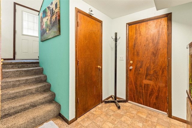 5900 Longview Dr, Missoula, MT 59803 - foyer entrance with baseboards, stairs, and stone finish flooring