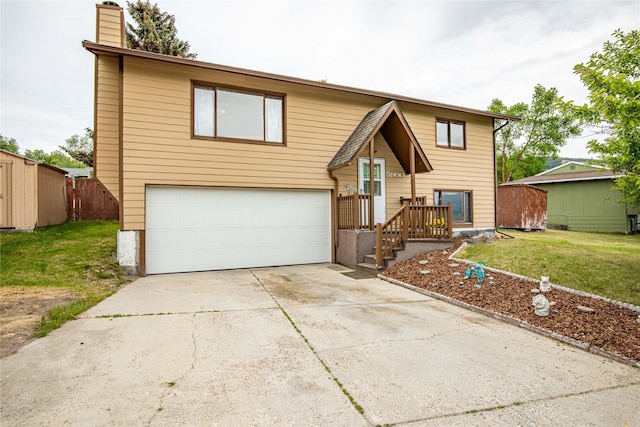 5900 Longview Dr, Missoula, MT 59803 - bi-level home with an attached garage, concrete driveway, a front yard, and a chimney