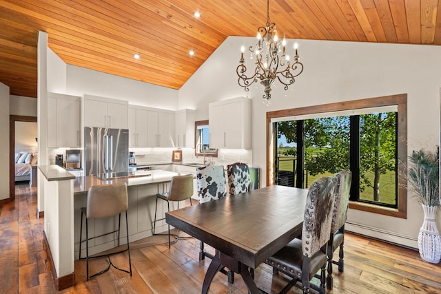 100 N Low Bench Rd, Gallatin Gateway, MT 59730 - dining room featuring wood ceiling, baseboard heating, high vaulted ceiling, a chandelier, and light wood-type flooring