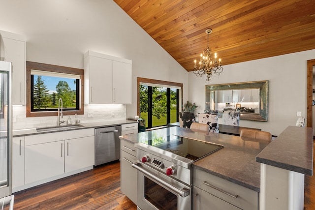 100 N Low Bench Rd, Gallatin Gateway, MT 59730 - kitchen with stainless steel appliances, a sink, a chandelier, wooden ceiling, and decorative backsplash