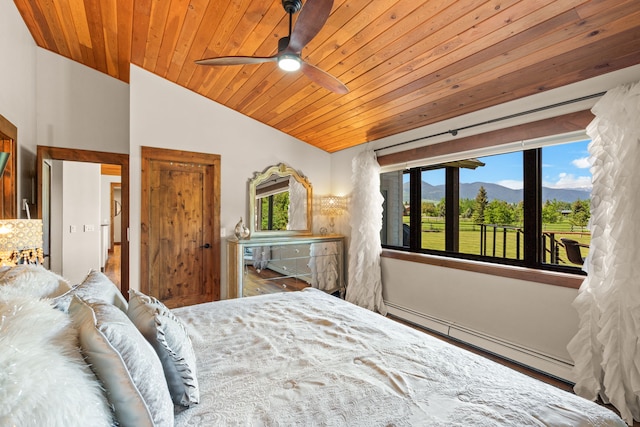 100 N Low Bench Rd, Gallatin Gateway, MT 59730 - bedroom featuring a baseboard radiator, wood ceiling, multiple windows, a mountain view, and lofted ceiling