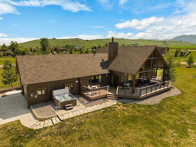 100 N Low Bench Rd, Gallatin Gateway, MT 59730 - rear view of property featuring an outdoor living space, a deck with mountain view, a chimney, and a shingled roof