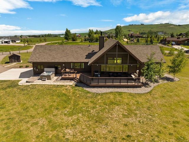 100 N Low Bench Rd, Gallatin Gateway, MT 59730 - rear view of property featuring a deck with mountain view, a yard, a chimney, roof with shingles, and outdoor lounge area