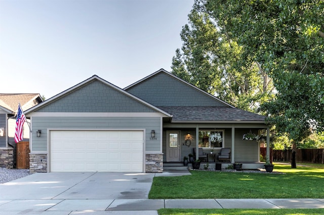 5334 Woodrow Ln, Lolo, MT 59847 - craftsman-style house with a porch, a garage, concrete driveway, stone siding, and roof with shingles