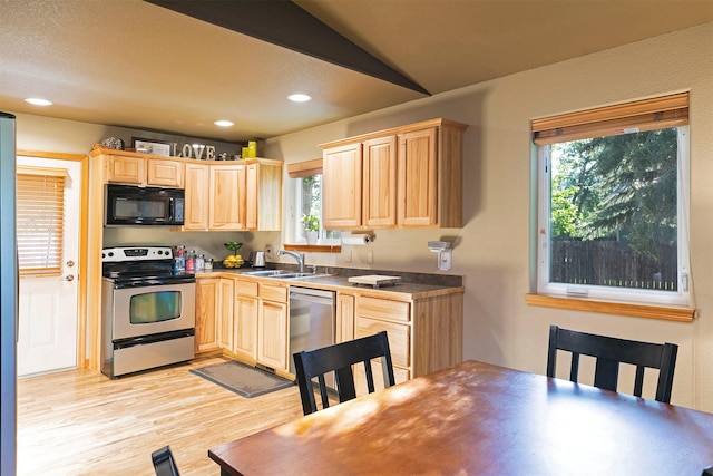 5334 Woodrow Ln, Lolo, MT 59847 - kitchen with appliances with stainless steel finishes, light brown cabinets, light wood-style flooring, healthy amount of natural light, and recessed lighting
