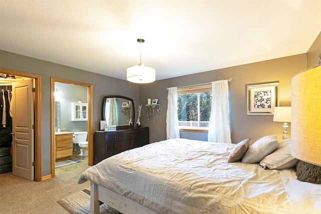 5334 Woodrow Ln, Lolo, MT 59847 - bedroom featuring a walk in closet, carpet, a closet, and ensuite bathroom