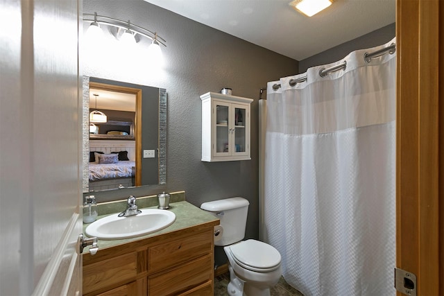 5334 Woodrow Ln, Lolo, MT 59847 - full bathroom with ensuite bathroom, vanity, a textured wall, and a shower with shower curtain