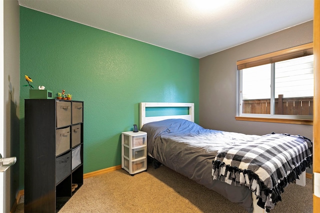 5334 Woodrow Ln, Lolo, MT 59847 - carpeted bedroom featuring a textured wall and baseboards