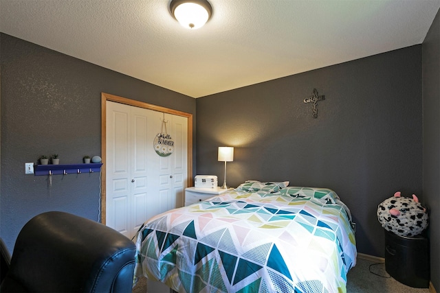 5334 Woodrow Ln, Lolo, MT 59847 - bedroom featuring a closet, carpet floors, and a textured wall
