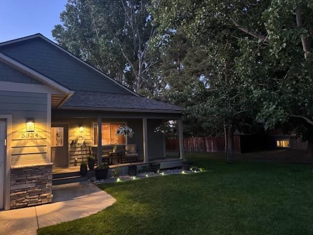 5334 Woodrow Ln, Lolo, MT 59847 - back of house with covered porch and roof with shingles