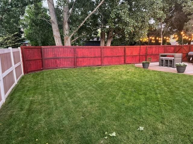 5334 Woodrow Ln, Lolo, MT 59847 - fenced backyard featuring a patio area